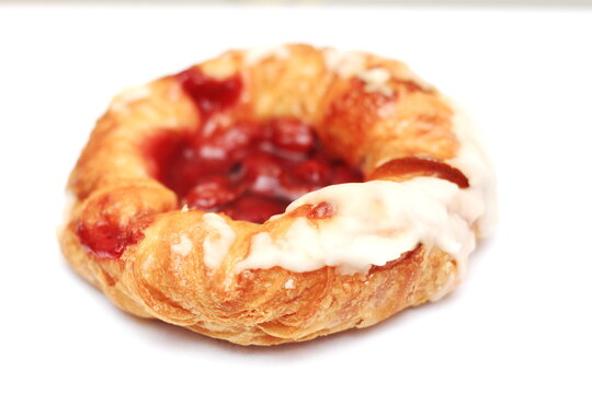 Cherry filled Danish or Danish bread placed on a white background.
