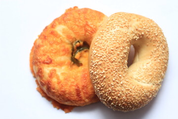 bagel, 2 donut shaped breads stacked on white background