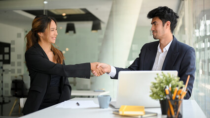 Businesswoman shakes hands with a successful male entrepreneur