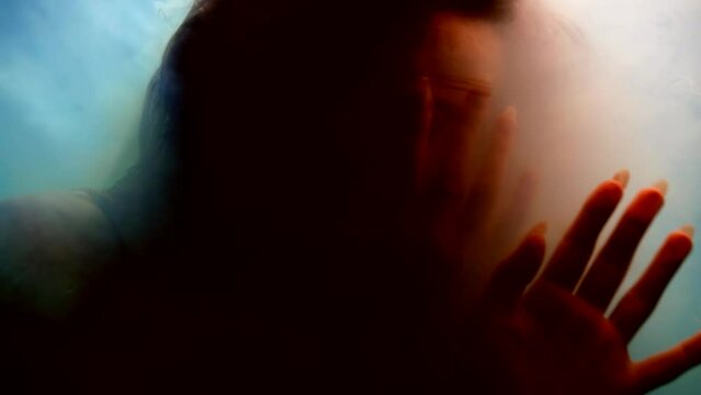 woman is floating underwater and disappearing in clouds of white smoke, abstract fantastic portrait