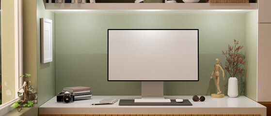 Modern home workstation with pc desktop computer against green wall.