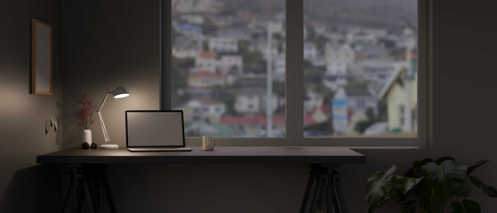 Modern home office workspace in the evening with laptop computer
