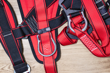 Safety belt for work at height with carabiner. Professional safety equipment for mountaineering and construction. Safety precautions. Close-up.