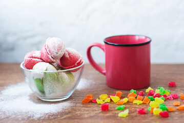 Multicolored cookies in the form of Nuts with filled cream, candied fruit and strainer and cup of...