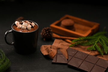 Homemade hot dark chocolate milk with marshmallows in a black ceramic cup