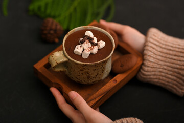 Top view, Woman hands serving a cup of tasty hot chocolate