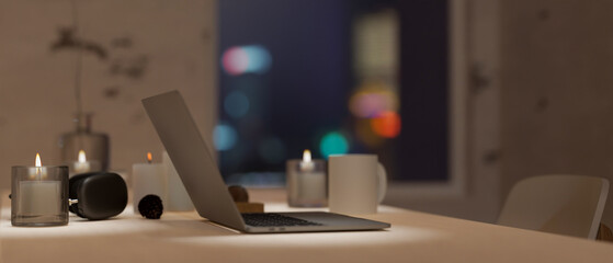 Modern working space in dark room in the evening with open laptop computer