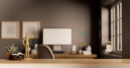 Wood tabletop with copy space against blurred modern office workspace in the background.