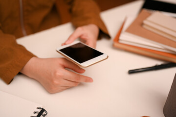 Female searching some online informations on her modern smartphone.