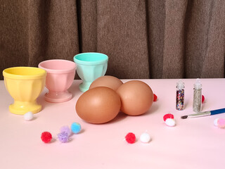 Easter eggs, multi-colored paints and brush for decorating souvenirs for celebration of Easter. Artistic work, handmade, creativity with children for decoration on Easter.