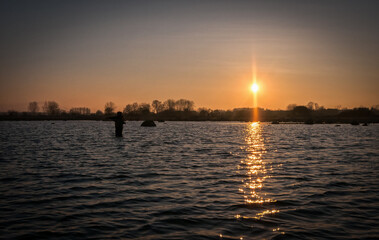 Angler fishing on the spring sunset