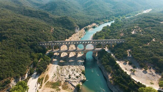 The Pont du Gard is an ancient Roman aqueduct bridge built in the first century AD. It crosses the river Gardon in southern France. Seen from above.