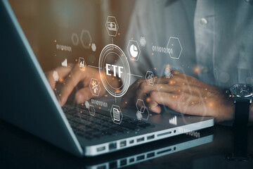 Person working on computer with icons of ETF Exchange traded fund stock market trading investment financial concept.