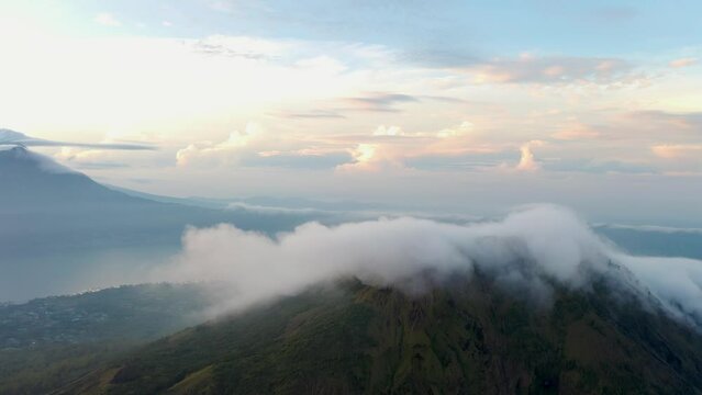 Aerial sunset of active volcano mount batur in Kintamani bali island Indonesia travel holiday destination, drone revealing scenic colourful natural landscape Mother Earth beauty