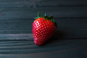 ripe strawberries on a dark wooden background