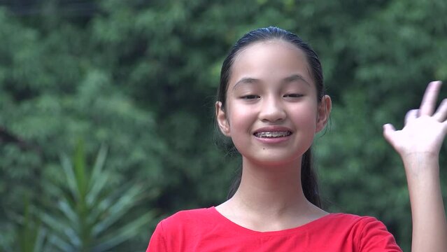 Friendly Asian Girl Child Waving Hello