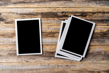 Blank photo frames for your photos on wooden background