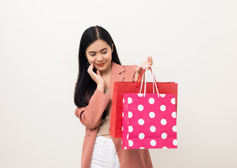 Portrait beautiful asian women in fashion style standing pose holding a lot of shopping bag on isolated white background. Attractive Happy business woman in pink suit going to shopping