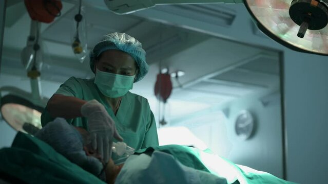 Doctor doing resuscitate a patient in oxygen mask resting on Bed in a hospital, CPR Cardiopulmonary resuscitation process
