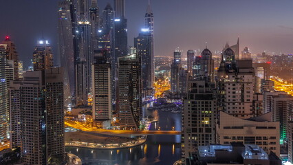 Fototapeta na wymiar View of various skyscrapers in tallest recidential block in Dubai Marina aerial night to day timelapse