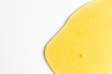 Fresh honey or synthetic oil or vegetable oil. White background. Copy space.