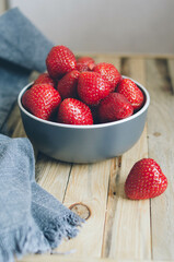 Fresh ripe strawberry on a plate and linen towel. Big red berries for a healthy breakfast in the village