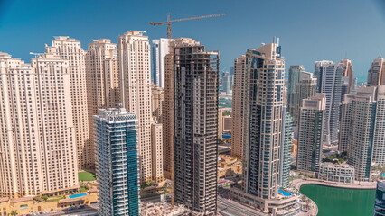 Jumeirah Beach Residence and original architecture yellow towers in Dubai aerial timelapse.