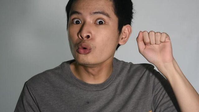 Asian Man Miming Knocking On Door Saying Hello