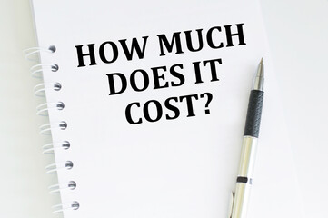 How Much Does it Cost. Business concept. Text on white notepad paper on light background