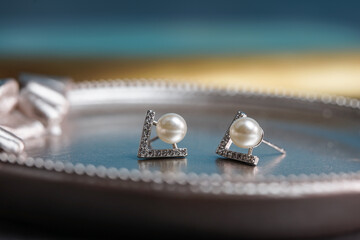 A beautiful Pearl Ear studs. Close-up of white pearl earrings.
