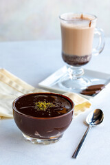 Chocolate pudding or supangle dessert on a white background. With hot chocolate on the side. close up