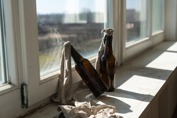Glass bottle filled with gasoline, a so called Molotov Cocktail, on the window in the house