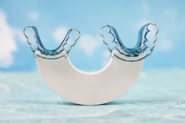 Fototapeten Retainer healthcare medical teeth mouth. Retainer blue on a sky background. © NOTE OMG
