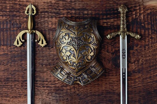 Armor of a medieval knight on the background of the texture of old wood. Religion and culture