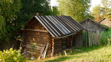 Beautiful rustic summer landscape. Old wooden log houses. Vologda region