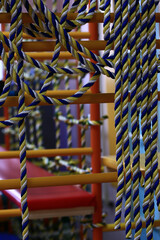 Beautiful knots of yellow-blue ropes. Blurred background. Close-up.