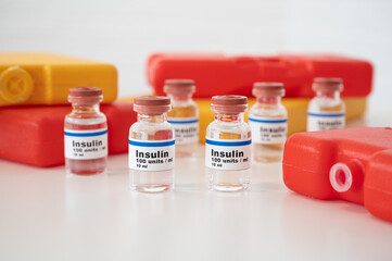 Insulin vials with cold packs against a white background: properly cooling and storing insulin. 