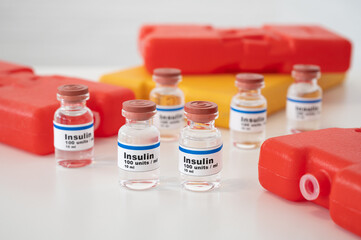 Insulin ampoules with cold packs against a white background: properly cooling and storing insulin. 