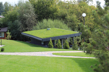 A modern village with turf roofs. Scandinavian type of green roof covered with sod on top.