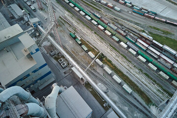 Aerial view of cargo train cars loaded with construction goods at mining factory. Railway transportation of industrial production raw materials