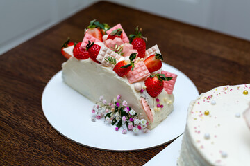 Homemade cake decorated with chocolate and strawberries.