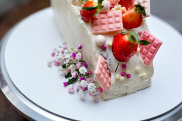 Homemade cake decorated with chocolate and strawberries.
