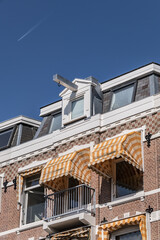 Close-up view architectural details of old (1800s) colorful building along river Amstel. Amsterdam, the Netherlands.