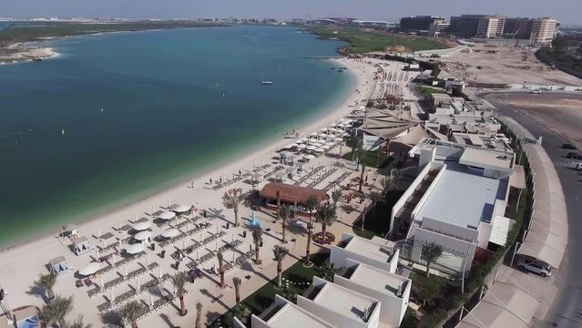 Aerial view of Yas Island, oveahead view of beach and skyline on a sunny day, UAE