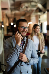 Businessman in office. Handsome businessman talking to the phone
