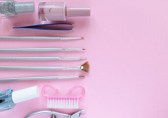 Layout of manicure accessories on a pink background. Nail care tools. Cosmetology. Personal care. 