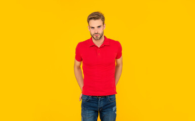 Fototapeta premium sexy man in red shirt on yellow background, mens beauty