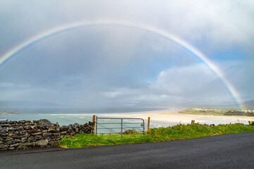 Fototapeta na wymiar Amazing rainbow above Narin Strand by Portnoo in County Donegal Ireland