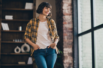 Photo of cute young bob hairdo lady look wear yellow shirt jeans at loft home in flat alone