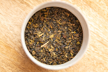 green tea dried petals flavored tea sprinkled to prepare a hot drink fresh portion healthy meal food diet snack on the table copy space food background rustic top view